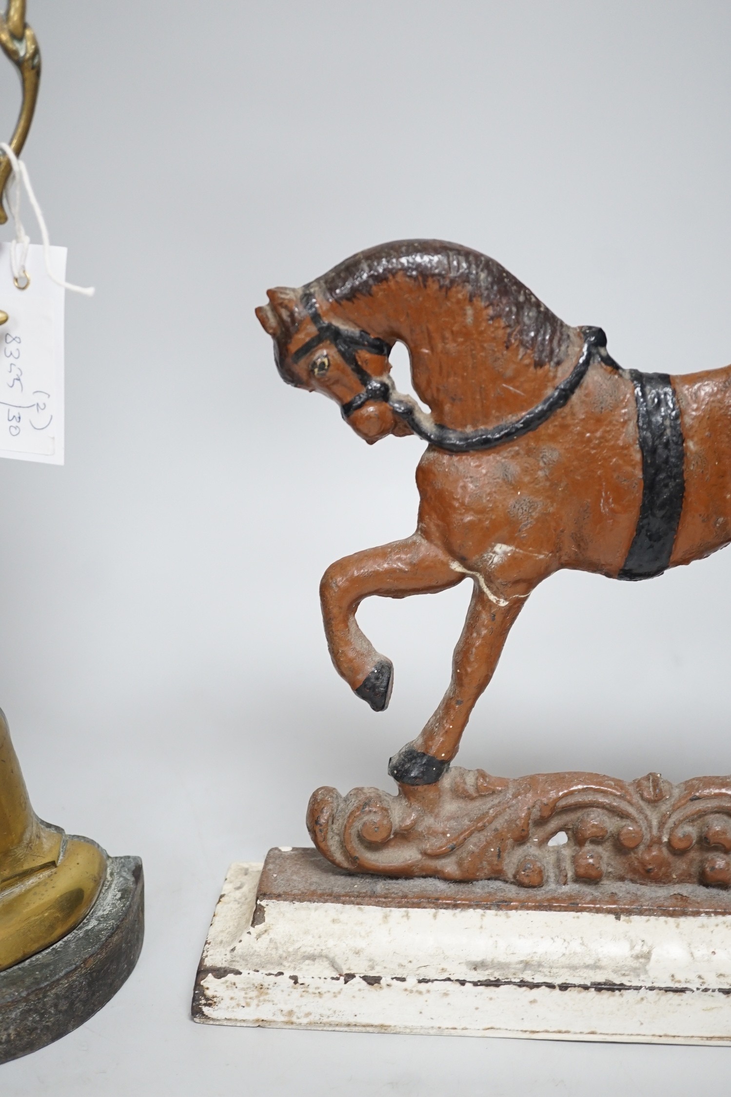 A Victorian bronze cherubic door stop, 45cm, and another painted equine door stop